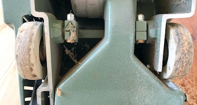 You can see some buildup on the wheels in this picture—and this is from only a few passes on a very sappy pine refinish. If you do not keep up with this throughout the job, the buildup will transmit as you're sanding and create horrific imperfections on the floor.