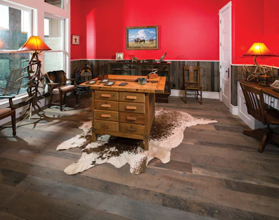The husband's study is his favorite room in the home. The antique woodworker's table in the center is made of maple and was restored by the homeowners.