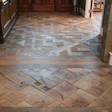 The house strikes a balance between hominess and sophistication. Nowhere is this more clear than the reclaimed wood Versailles and end-grain block patterns in the entryway.