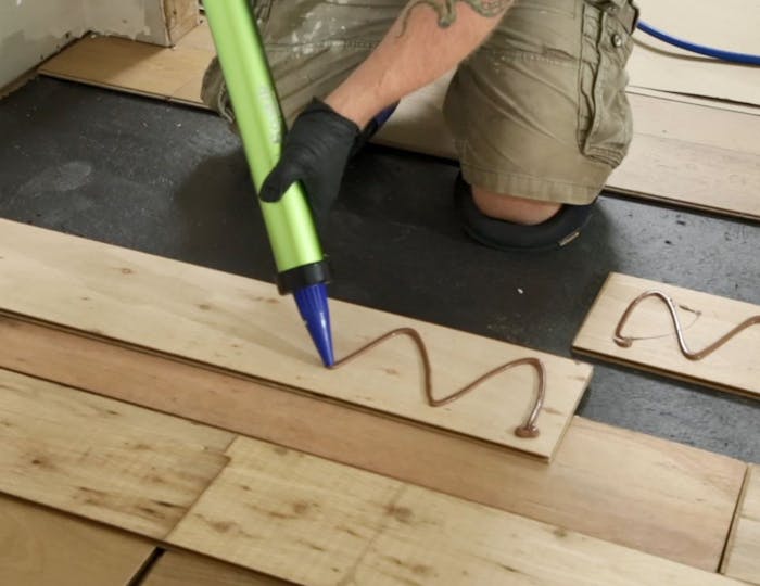 Adhesive used with any wood flooring should be elastomeric, which allows it to move with the wood as it shrinks and swells with changes in relative humidity.