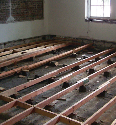 Decades of damage were evident on Ayres Hall's old wood floors (top), including spilled paint and plaster. In addition to renovating the floors, Praters repaired damaged subfloors (middle and bottom) so they could accommodate new utilities.