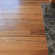 This floating click strand bamboo floor is beginning to show a large gap due to being installed tight against the hearth without any expansion space in the spot indicated with the arrow.