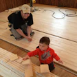 Merrill and his 3-year-old son, Connor, at work on the school job site.