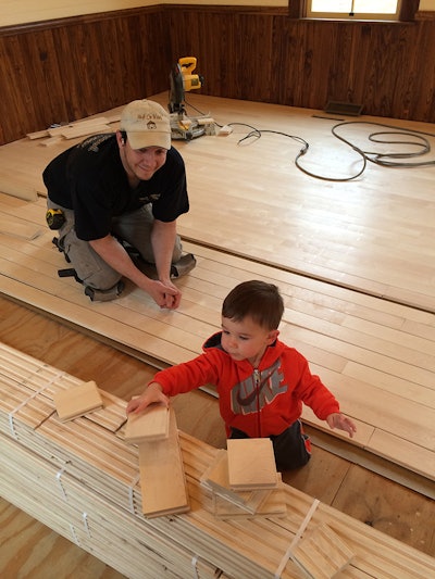 Merrill and his 3-year-old son, Connor, at work on the school job site.