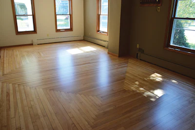 This patterned floor is about 60-year-old maple. It took a lot of work to get it flat: I had to use a multi-disc sander to make sure all the scratch marks were gone from where the big machine overlapped and went across the grain (this is where leaving some dust on the floor helped me see some of the scratches).