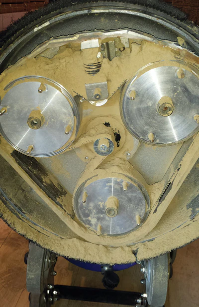 On this three-disc sanding machine, the seal on the bottom of the machine had broken, allowing all the dust to go up inside directly on the belts, bearings and pulleys. Eventually the dust will paralyze the machine, locking up the drivers so it can't spin freely.