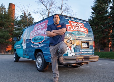 Felix Roman of Wood Flooring Doctor with his work van, which won Best Exterior Graphics in the 2022 WFB Truck & Van Contest.