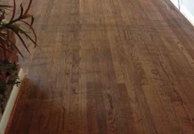 âThis customer used a wet string mop, back and forth against the grain, to mop off all the sanding dust before stainingâbut the wet mop water-popped the grain, and evidence of his graceful, sweeping strokes were revealed when the stain was applied.â