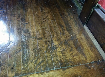 âThe actual creator of this horror did not rent from us, but the job was done edger-only, with a poorly dressed edger that was difficult to control. The customer had no inkling that those deeper edger scars would accept more stain than the surrounding floor and make them stand out like that.â
