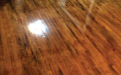 “This one still confounds me. I think the customer inherited an old rug line that didn’t sand out and was not hidden by the stain. I also think that the original layer of finish was not quite fully sanded off, which prevented even absorption of the new stain coat.”