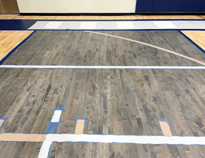 This court shows the newer trend of using stain; in this photo game lines are being painted on top of it.