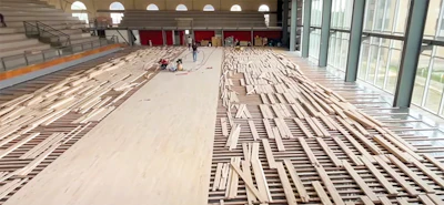 This photo from a job we did training for in Argentina shows a basic floating sleeper system: The sleepers are not anchored, and they have resilient pads underneath them for cushioning. Systems like this are still commonly used in the U.S. but typically have a layer of plywood over the sleepers; this makes the floor stronger for situations such as when a lift has to go on the floor to fix a light or a scoreboard.