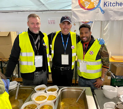 Chris Yates (left) with Nantucket Cares volunteers Brian and Johnathans serving meals at the World Central Kitchen.