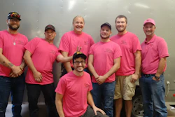 Jason Carter (far right) and his team sporting the company's pink shirts for breast cancer awareness.