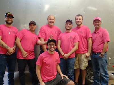 Jason Carter (far right) and his team sporting the company's pink shirts for breast cancer awareness.