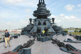 Thick yellow pine planks on the deck of the USS Texas, above, are being restored by volunteers, below.