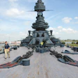 Thick yellow pine planks on the deck of the USS Texas, above, are being restored by volunteers, below.