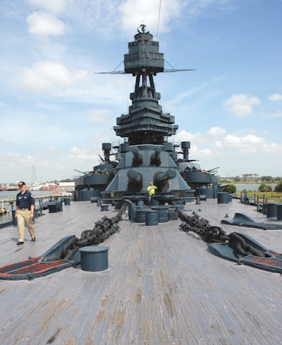 Thick yellow pine planks on the deck of the USS Texas, above, are being restored by volunteers, below.