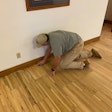 It’s important to make sure the edges are abraded just as well as the field. Here, Scott Bowman of Bowman’s Hardwood Floor Refinishing abrades the edges on a floor made of cutoffs from trailer flooring.