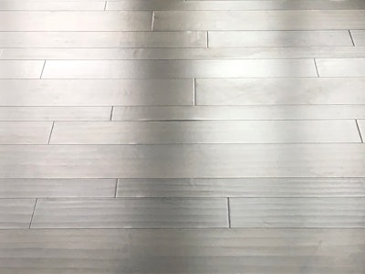 A 16-gauge staple was used on this 1/2-inch-thick engineered floor, causing the dimples you see.