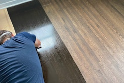 Wood floor coloration options are as varied as their application techniques; here a solvent-based stain is being applied.