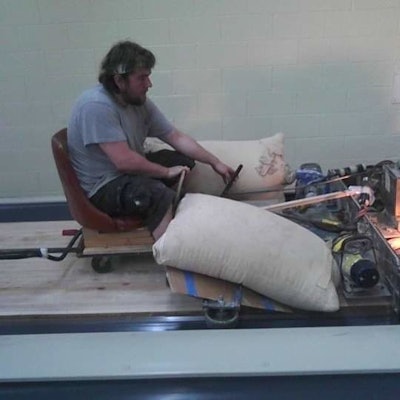 In this photo I'm running the Tru-Line Maxi Sander—a big 44'-inch drum sander we used for finish removal and our initial leveling. Dan Hawke's grandfather, Dan Gallichio, built that machine. (Read a WFB article about him and his machines here.)