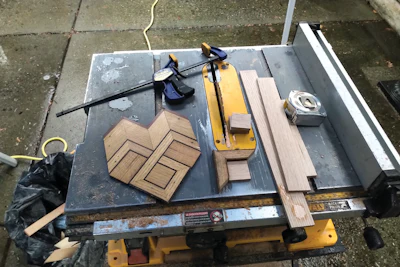 I built new corner blocks (not using a backsaw like my dad did!). The feature strip with two dark inlay lines is actually salvaged material. When we do tearouts, we save the feature lines if they are not sanded to death. We continue to build the border from the outside in toward the field.