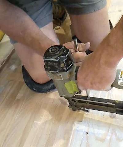 When racking out top-nail, we use one small piece across a span of rows to flatten them, then use leverage against a scrap piece to tighten them as we nail a few boards just to hold the flooring in place until the full-on top-nailing happens using the nailers you see below.