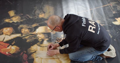 A still from a documentary being made about Jakko Woudenberg's efforts to recreate The Night Watch painting using wooden cubes.