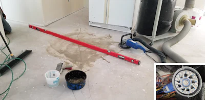I used water to keep the dust down when grinding this subfloor—even though I had a vacuum. The spatula was for picking up the slurry created, which I put in the blue container. Of course I had the level there, or else I would have had no way of knowing if I made any progress.