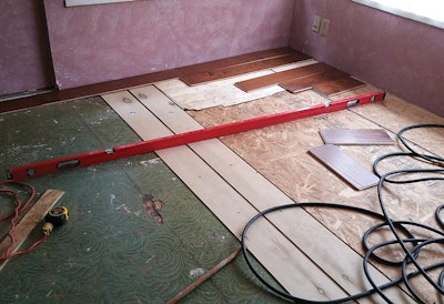 We used sheets of plywood and veneer skins in multiple layers to get it flat, and after nailing and gluing the plywood and skins, the floor was solid.