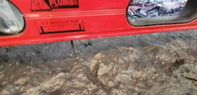 Fortunately, I had more than enough room to work, and I did not have to excavate the existing concrete. I used Tapcon screws set in the concrete and adjusted each screw by turning it until the required elevation at the top of the screw head was met with a level.