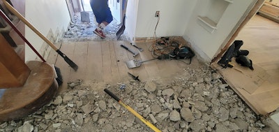 We finally found the subfloor after almost 6 inches of excavation. There was no subfloor to level, because there was no floor at all. This was Amazon-rope-bridge stuff over a chasm 1,000 feet high. We were on our own with no similar applications to glean information from.