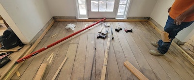 The laser and 8-foot level were our primary tools here. We used 3-inch screws to secure the rim joists to the existing structure. We put the bubble in the middle of the lines of the level at every instance, because this step was the basis for everything that came after.