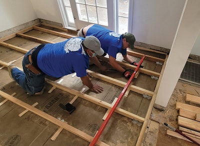 We used a lot of shims here to set the elevation of each board—foot by foot. Simpson A35 Teco clips secured each board firmly to the subfloor, and the shims were glued and nailed. There was zero deflection in the joists as we walked over them (we walked every board and tested this before we moved on).