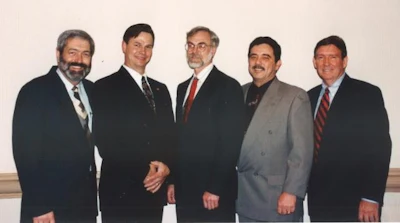 The instructors who taught together in Hong Kong later posed for this photo together (left to right): Don Bollinger, Daniel Boone, Mickey Moore, John Bast Jr., and Coley Armstrong.