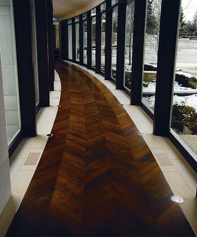 Quartersawn walnut was glued down in a bent herringbone pattern, bordered on each side by stone, and coated with penetrating oil.