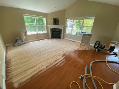 For this aluminum oxide floor, Joshua Feck of Traverse Woodworks in Traverse City, Mich., started with diamond plates on his Bona Power Drive “to scratch up the surface. I’d let the plates cool while removing what’s left of the finish with 36-grit with the big machine.”