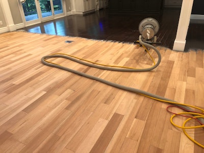 Matthew McGrew of Kenna, W.Va.-based Wood Floors by Book Smart sent this photo of a sand job with aluminum oxide: 'On this solid exotic floor I was removing the factory finish with the Bona diamond plates,' he says. 'Afterward, I used my Floorcrafter to clean up the scratches before moving on to planetary sanding with the Power Drive.'
