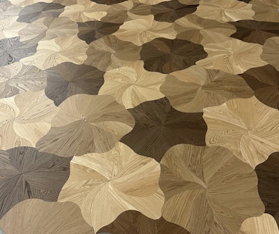 'Blooming' wood floor design is achieved by installing four unique shapes in a random pattern to generate a non-repetitive design.
