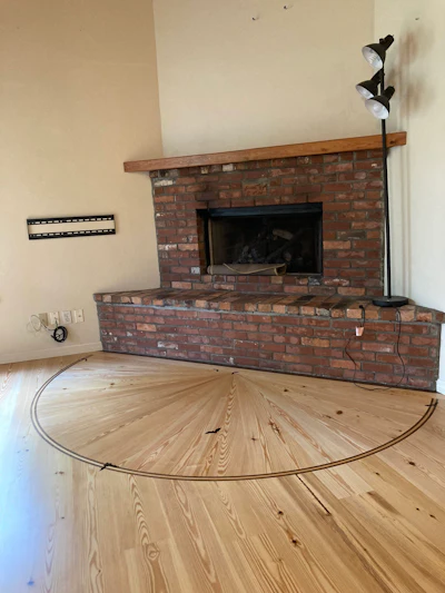 Bats on the floor appear to be flying out of the fireplace.