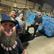 Kristopher Jeter, right, and other volunteers collect pallets of water to deliver to Hurricane Helene victims.