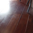 Wood floor “polishes” sold at box stores can often leave wood floors looking like this, and they must be removed before recoating.