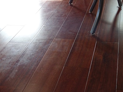 Wood floor “polishes” sold at box stores can often leave wood floors looking like this, and they must be removed before recoating.