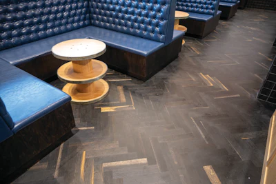 The finished herringbone flooring in the restaurant seating area.
