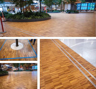 The completed flooring showing the seamless expansion tracks, including where the flooring meets the terrazzo flooring, as well as some of the many tree wells.