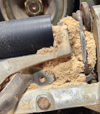 An upper roller assembly packed with dust.