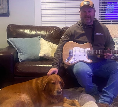 Dave Hoyt holds Stephen Diggins' wood floor guitar.