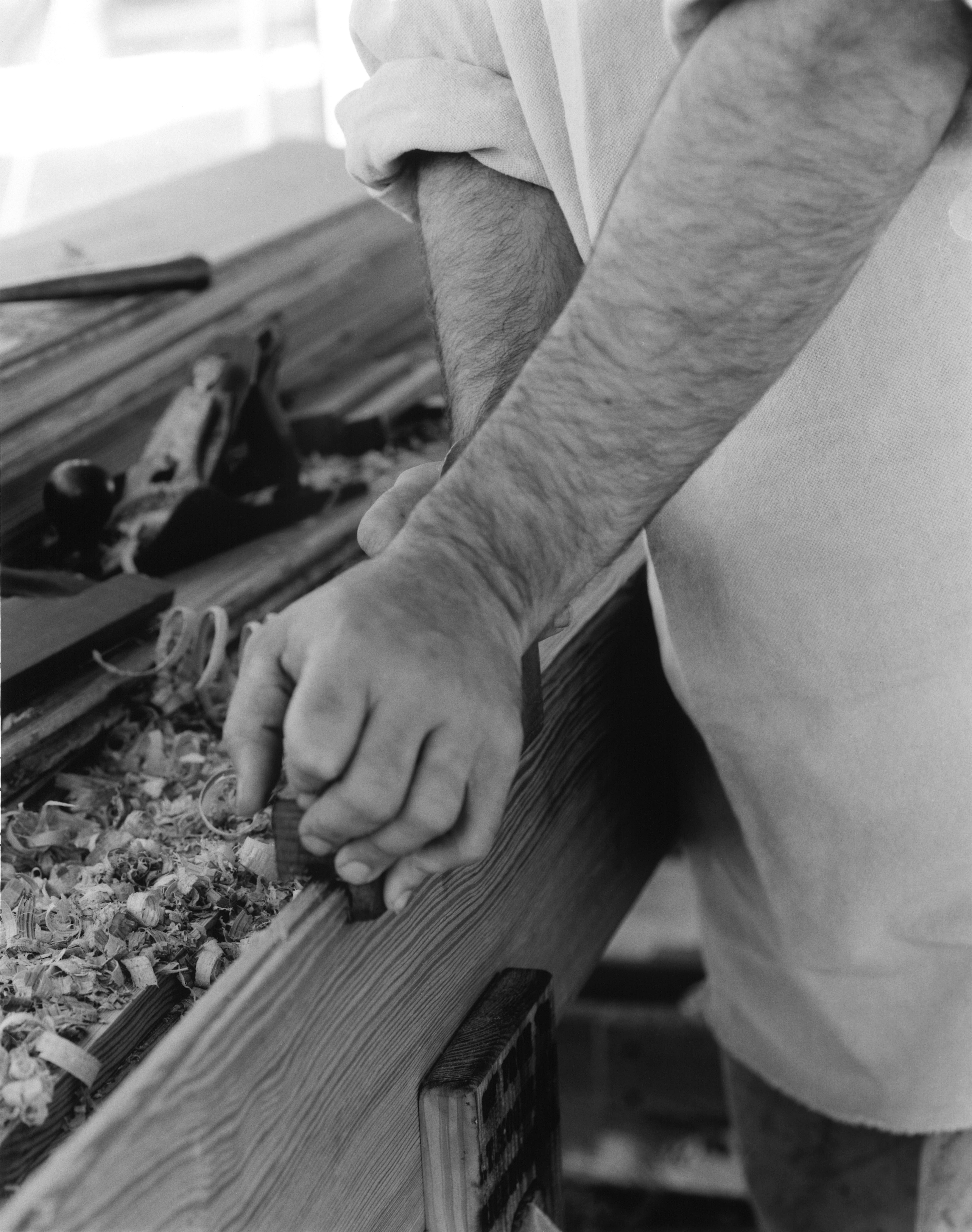 The historic way of crafting tongue-and-groove heart pine wood flooring, before machinery: At an event called Field Day of the Past in Goochland County, Va., I'm using a tongue cutter plane to create the tongue side of a heart pine board, starting at the front of the board and working my way back, constantly moving back and forth. (Arthur Jenkins)
