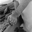 The historic way of crafting tongue-and-groove heart pine wood flooring, before machinery: At an event called Field Day of the Past in Goochland County, Va., I'm using a tongue cutter plane to create the tongue side of a heart pine board, starting at the front of the board and working my way back, constantly moving back and forth. (Arthur Jenkins)